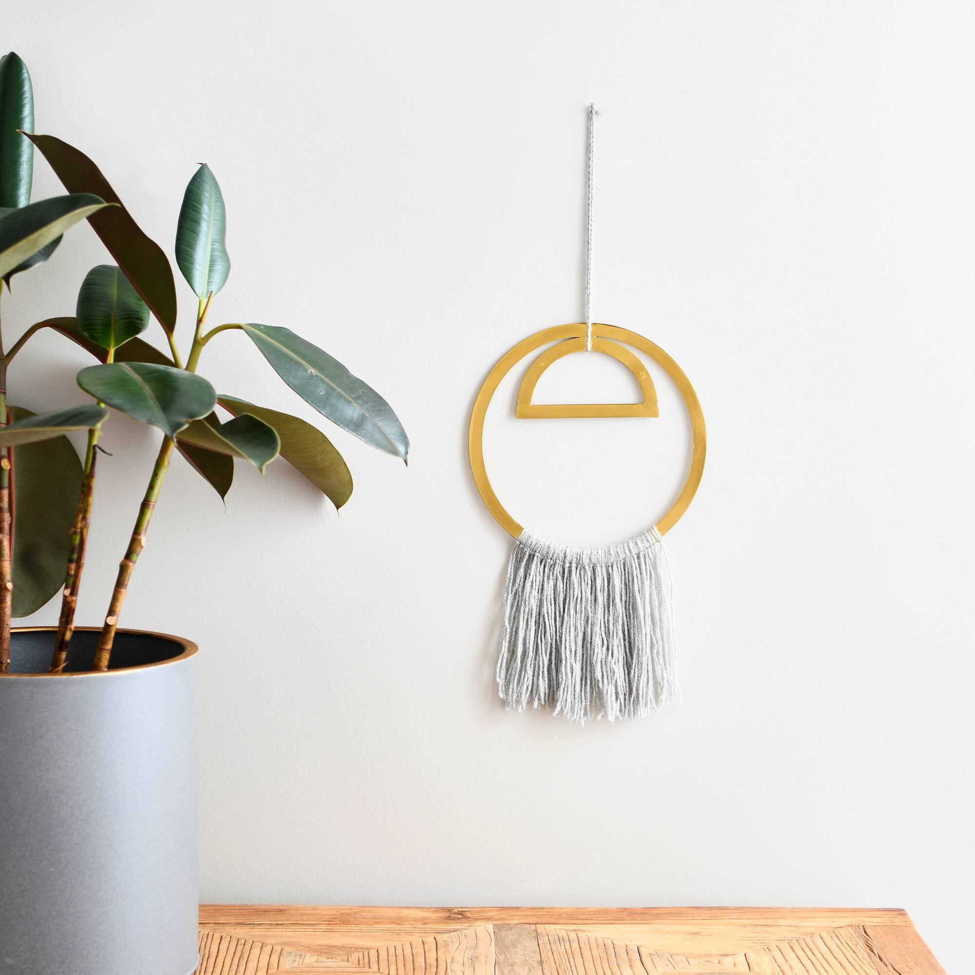Hello Honey® Gold Round Metal Wall Hanging with Tassel